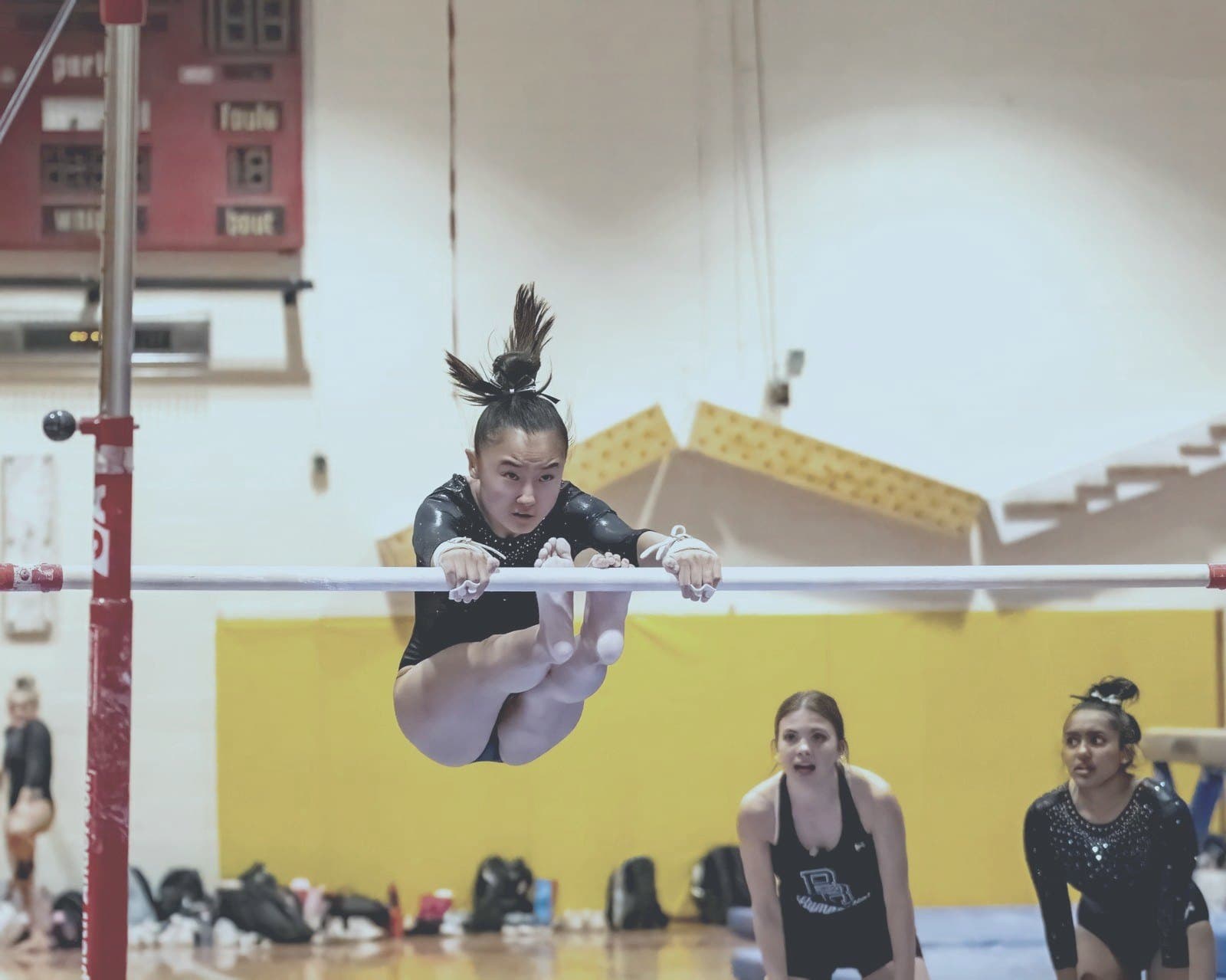 Gymnast grips the bar with complete focus